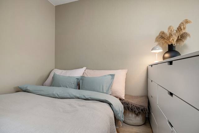 Bedroom with bed and chest of draws