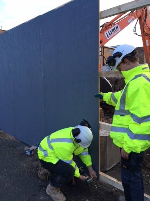 Trinity Fencing CIC - two men in high-vis putting up a fence