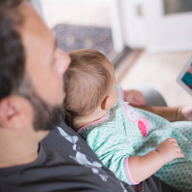 Dads Unlimited - dad reading with baby