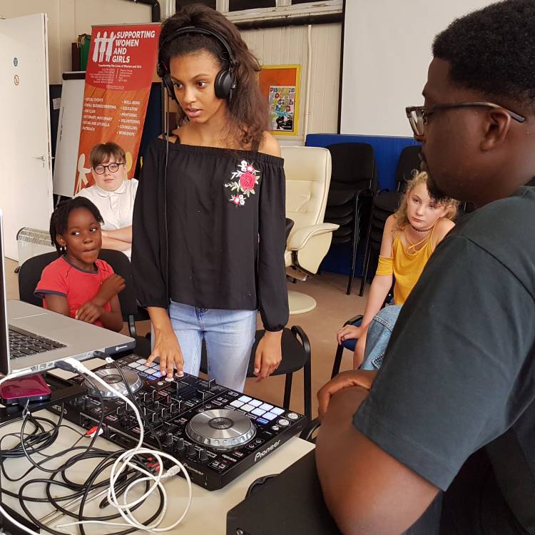 Diversity House - girl using DJ equipment 