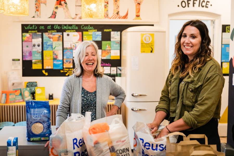 The Umbrella Café CIC - Two women packing bags at Foodbank