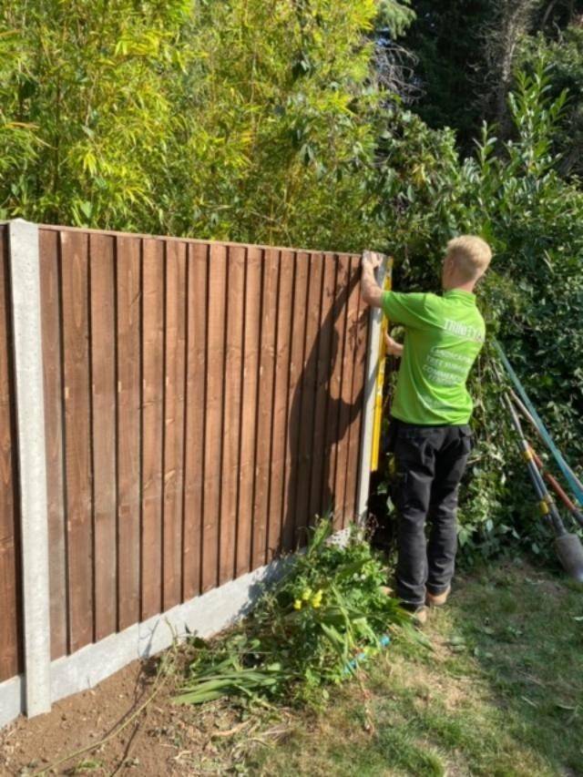 Trinity Fencing CIC - man putting up a fence