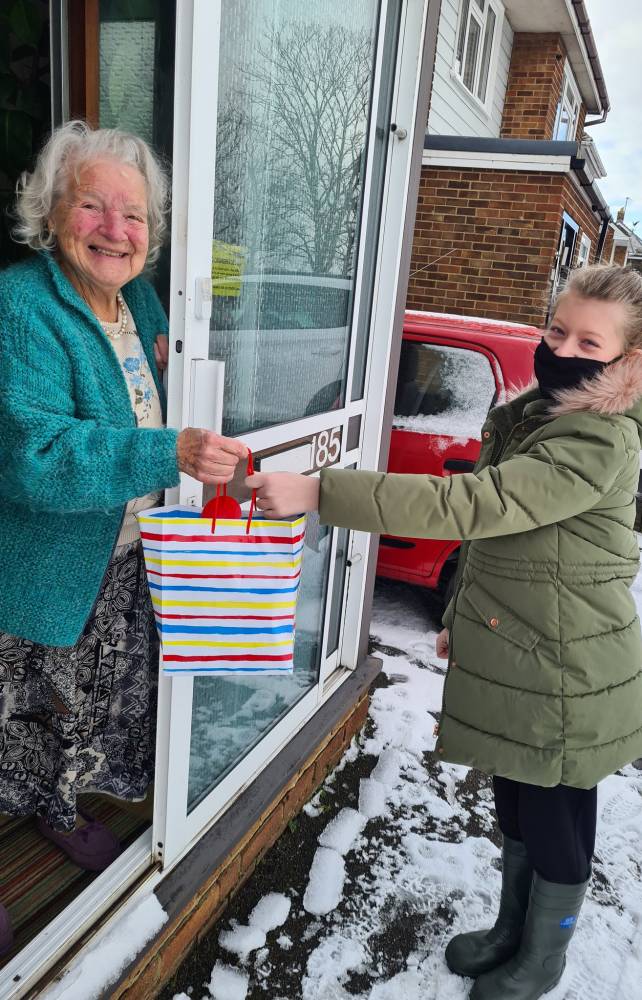 Swale CVS - Young volunteer delivery package to elderly member