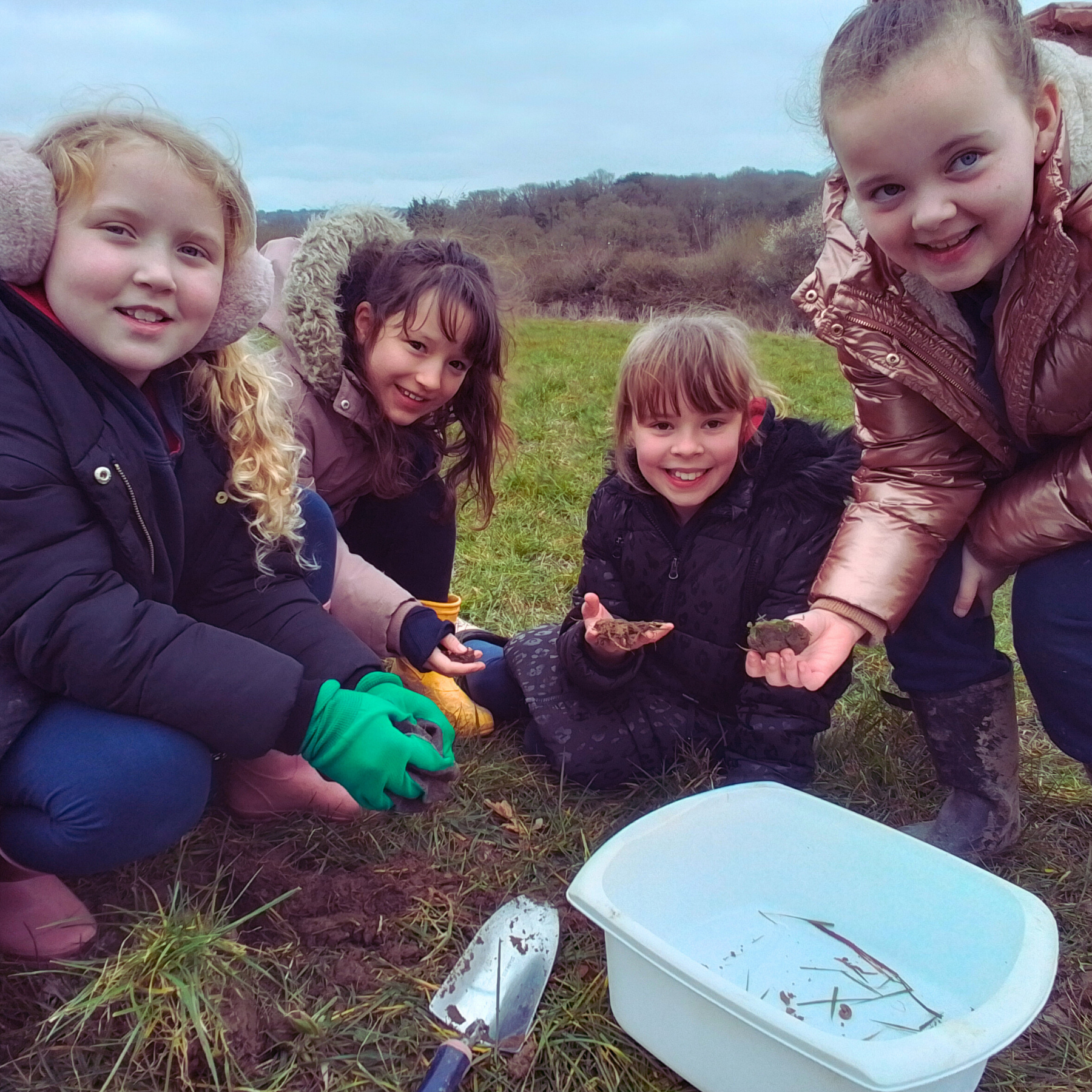 three volunteers in a community garden
