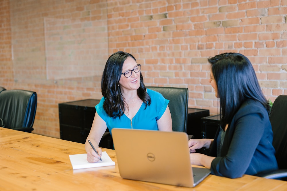 Two smiling women in a meeting