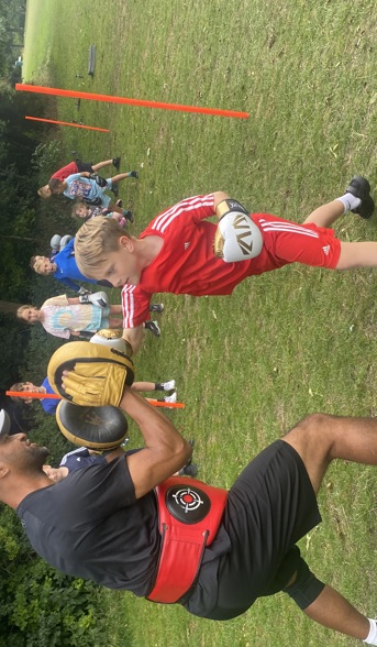 Boy boxing with coach