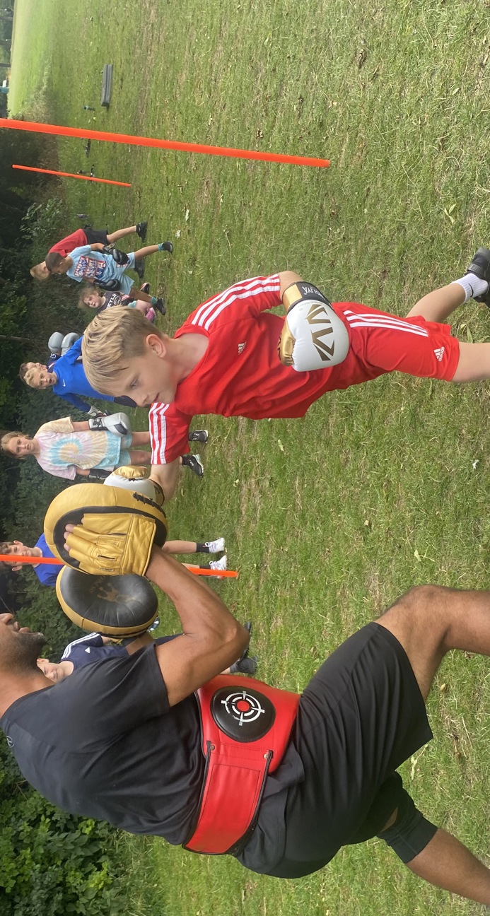 A boy boxing with a coach
