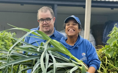 Spadework - man and woman smiling and holding vegetables